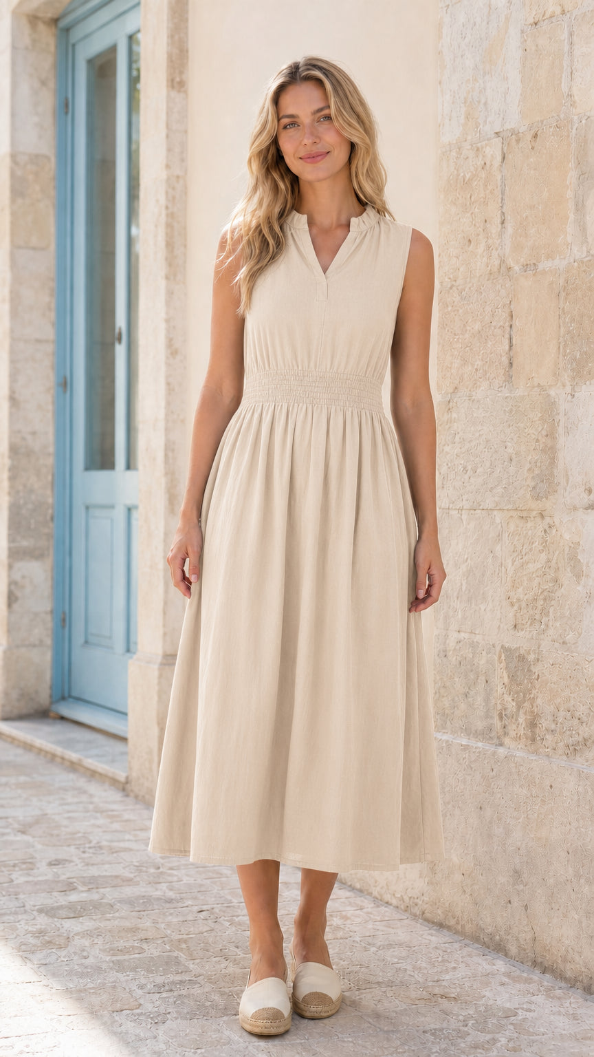 Full front view of woman wearing beige sleeveless smocked midi dress