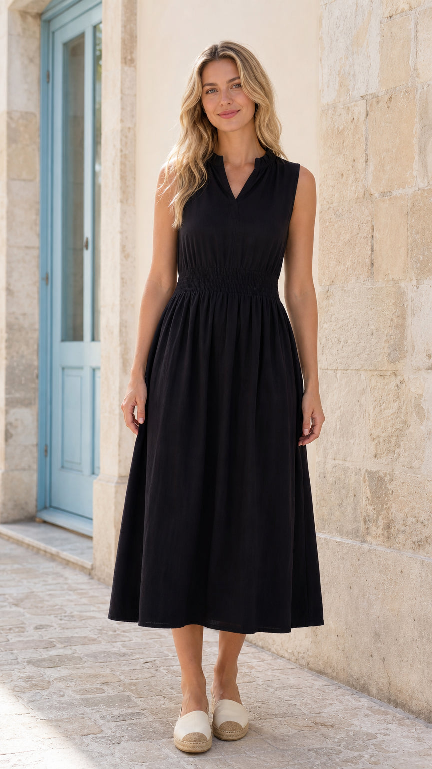 Full front view of woman wearing black sleeveless smocked midi dress