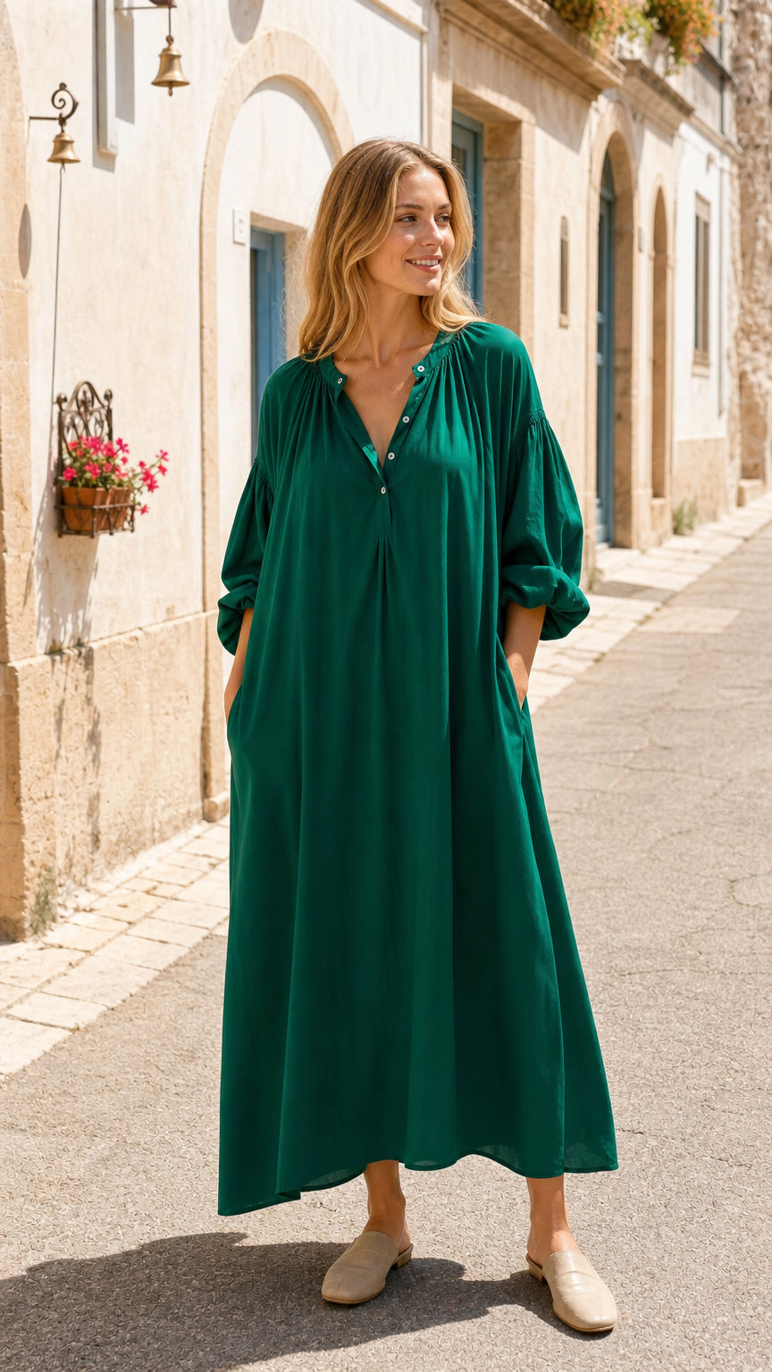 Front view of woman wearing emerald green long sleeve maxi dress outdoors