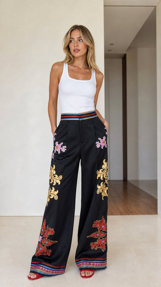 Front view of model wearing black embroidered wide-leg pants