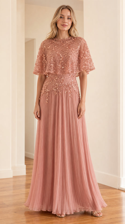 Front view of woman wearing rose pink embellished cape overlay maxi evening dress
