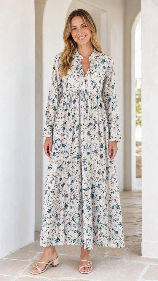 Front view of woman wearing off-white floral long sleeve maxi dress