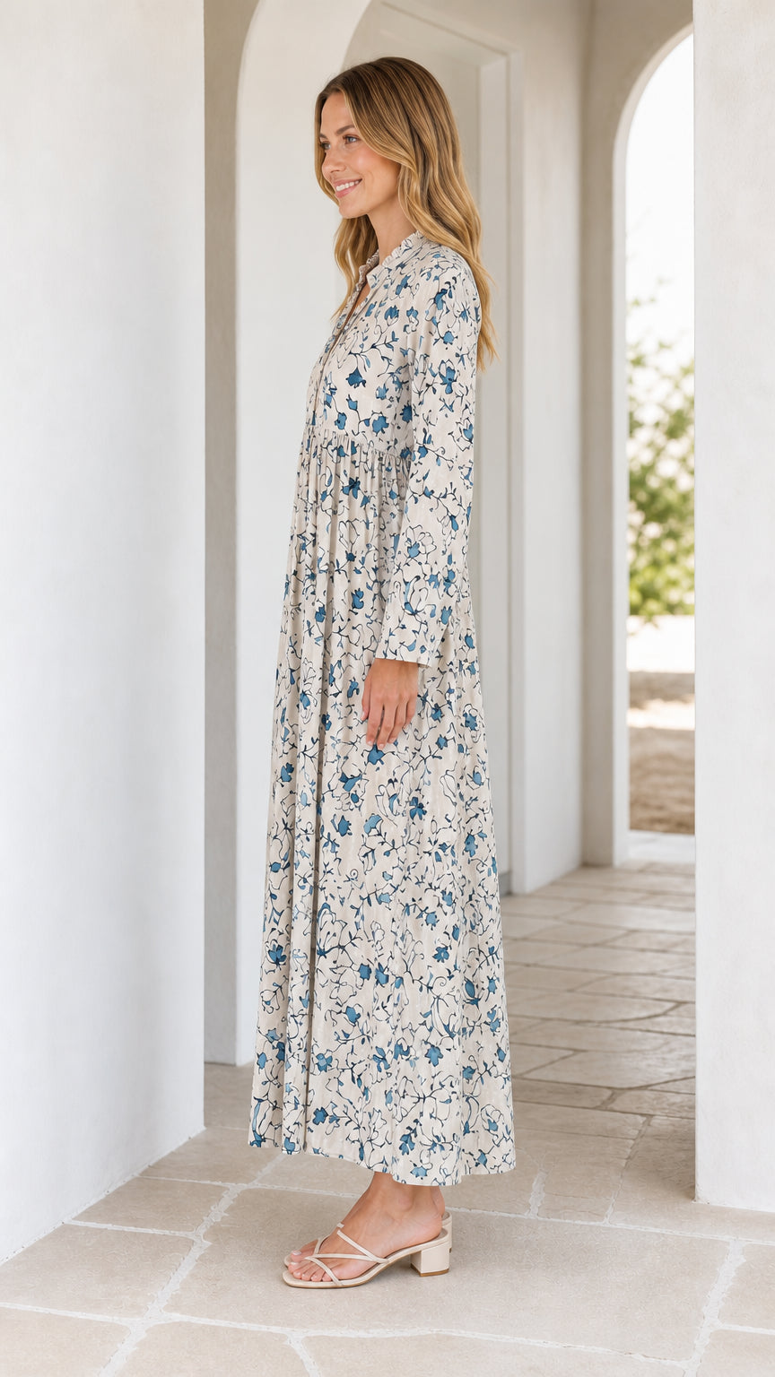 Side profile view of off-white floral maxi dress