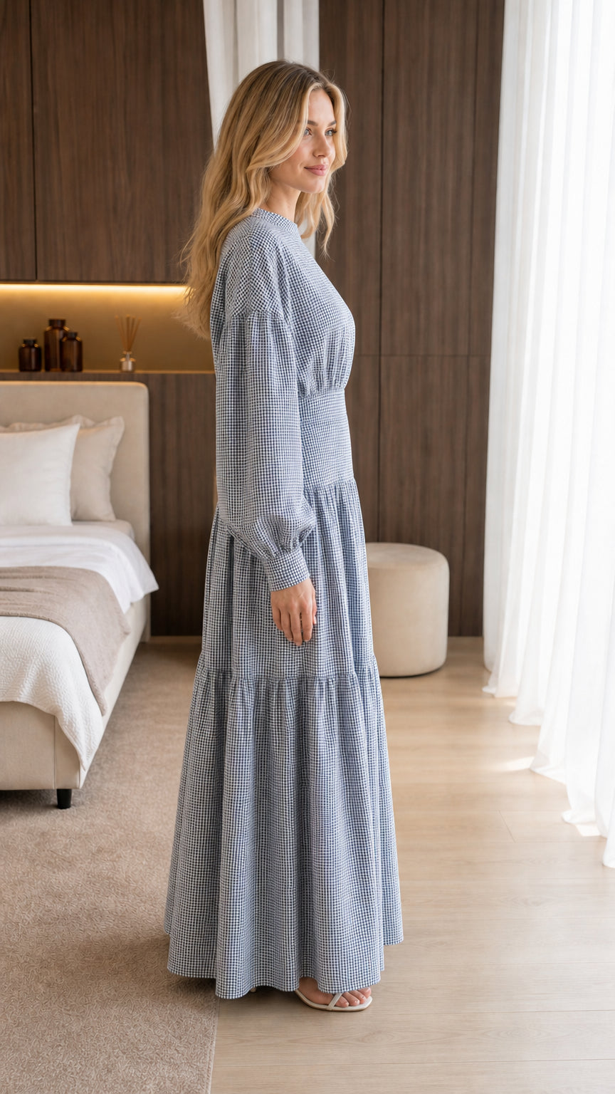 Side view of model wearing blue gingham maxi dress