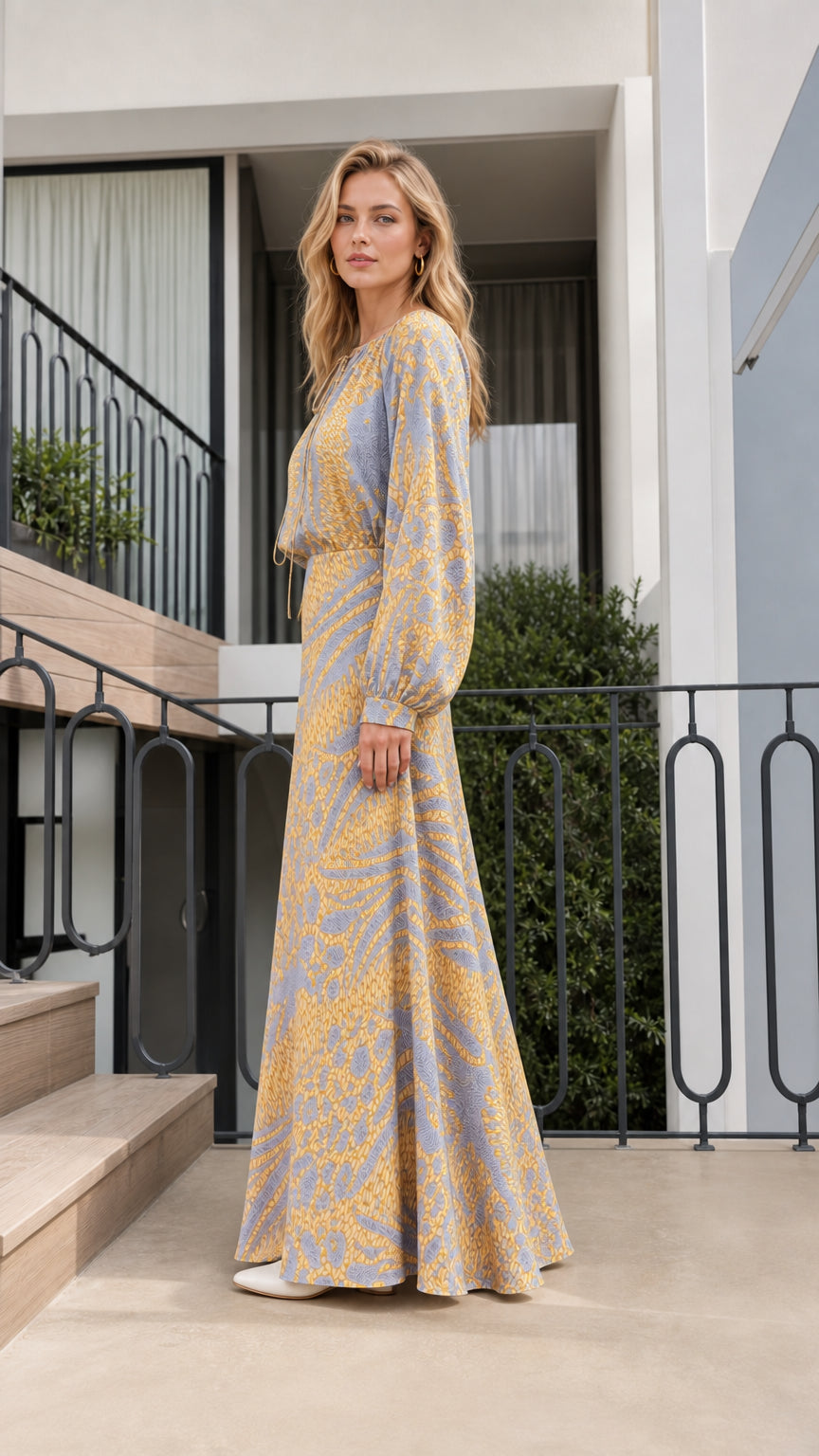 Side profile of model in blue printed maxi dress