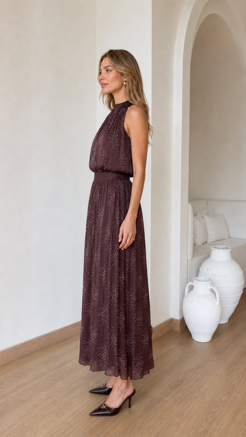 Side profile of model in brown glitter chiffon maxi dress