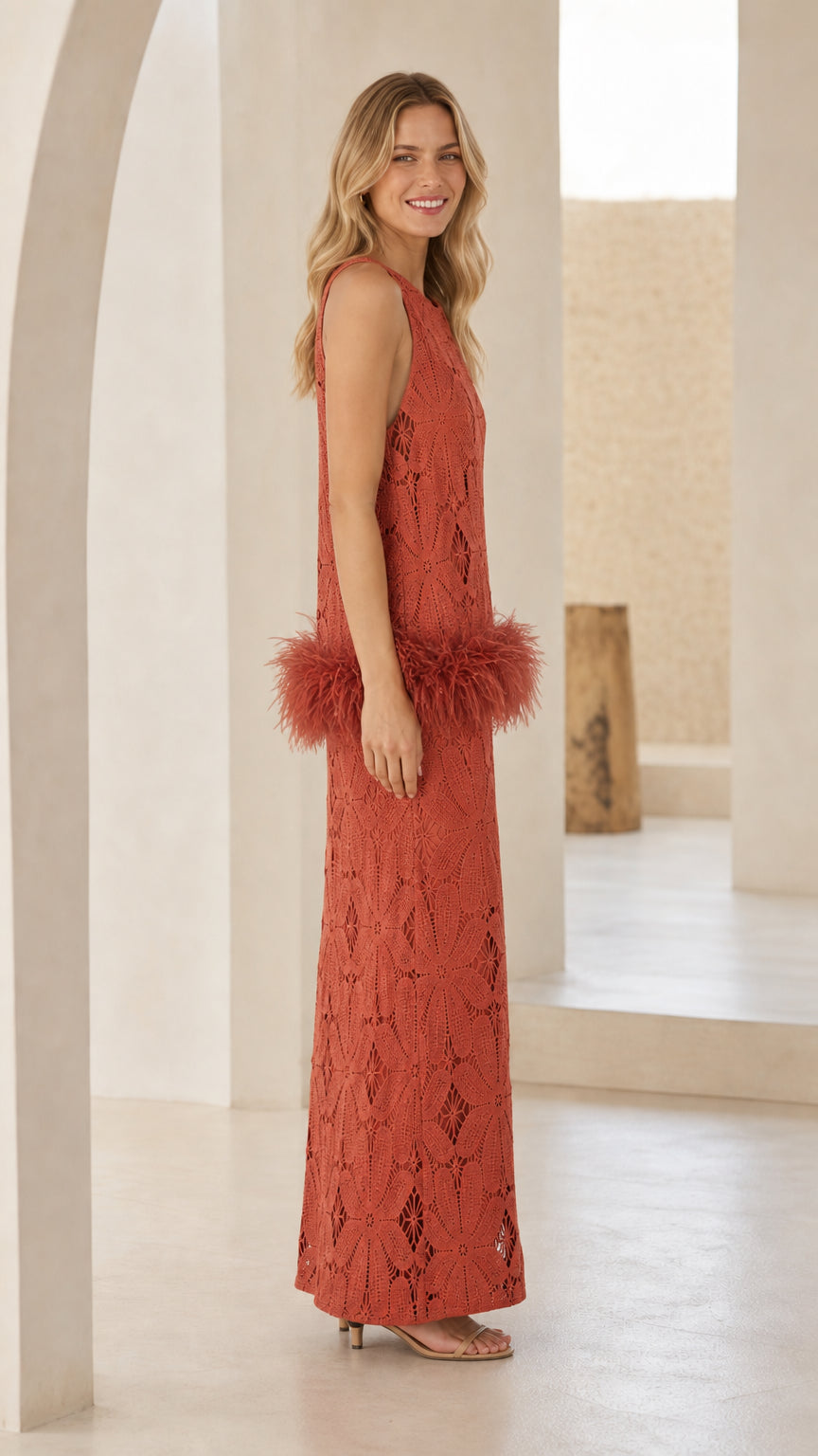 Side profile of model in rust lace maxi dress