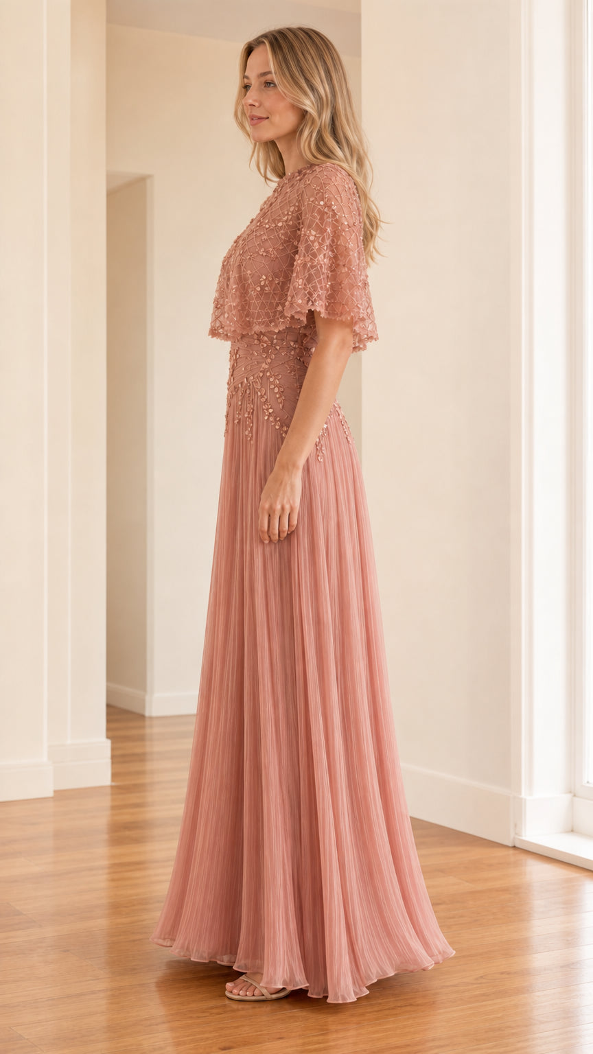 Side profile view of rose pink evening gown showcasing pleated skirt