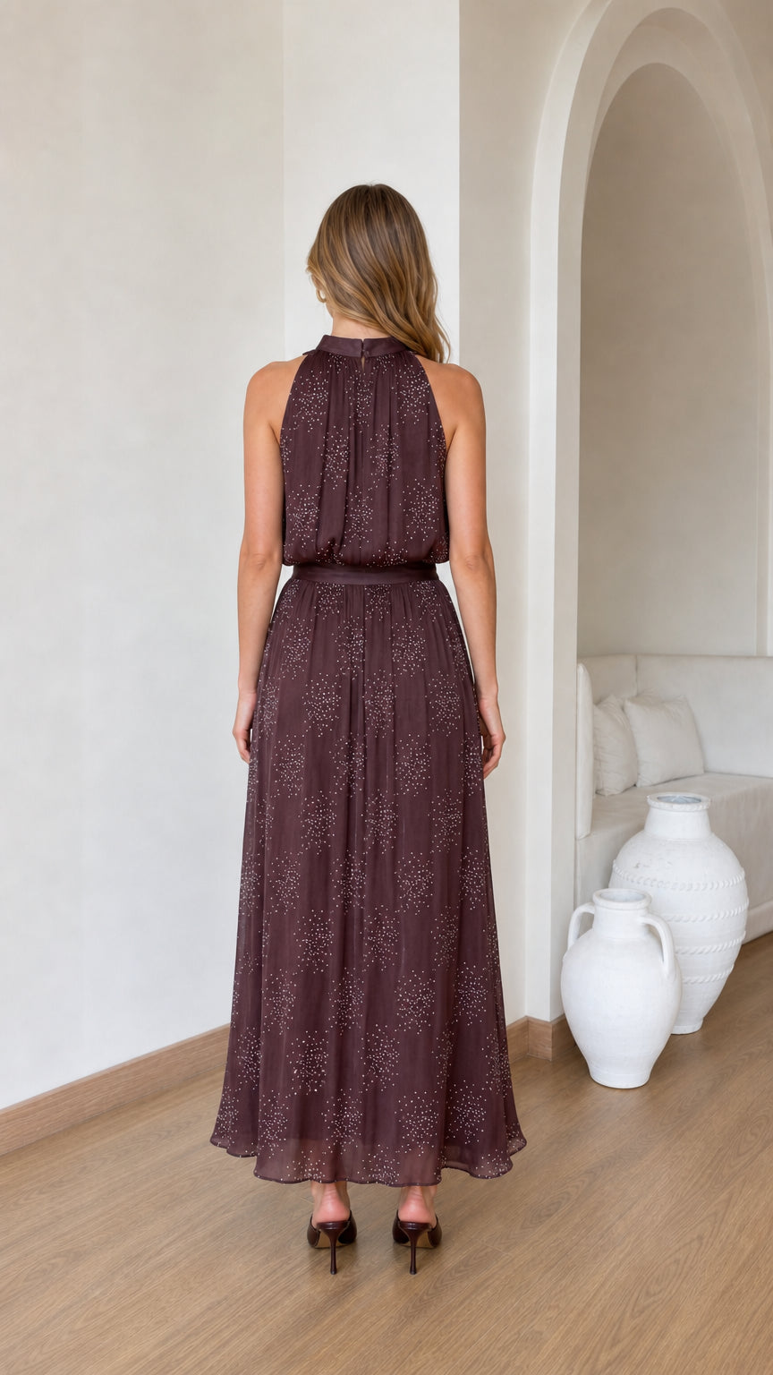 Back view of model showcasing pleated brown maxi dress