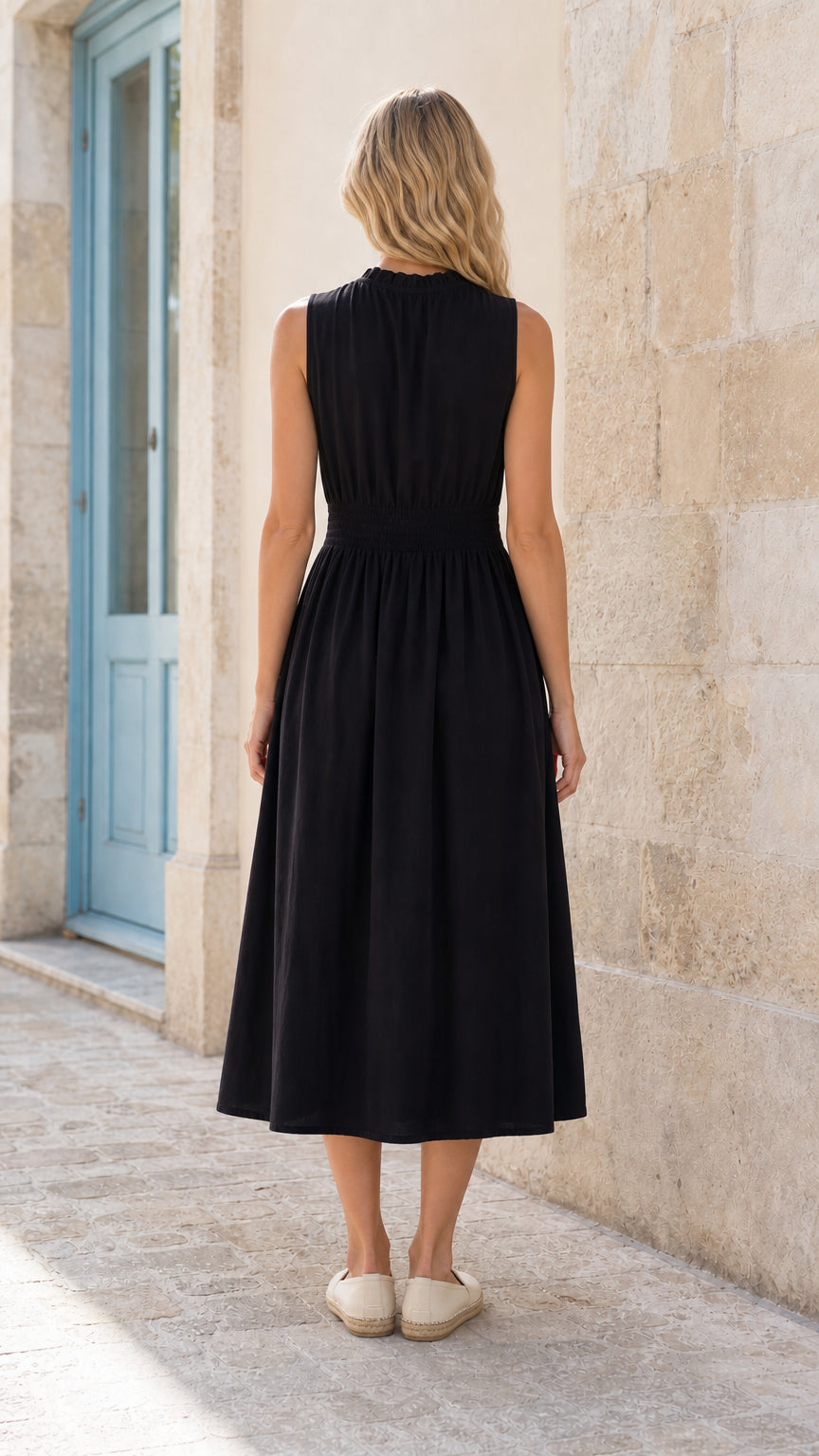 Back view of woman wearing black smocked waist midi dress