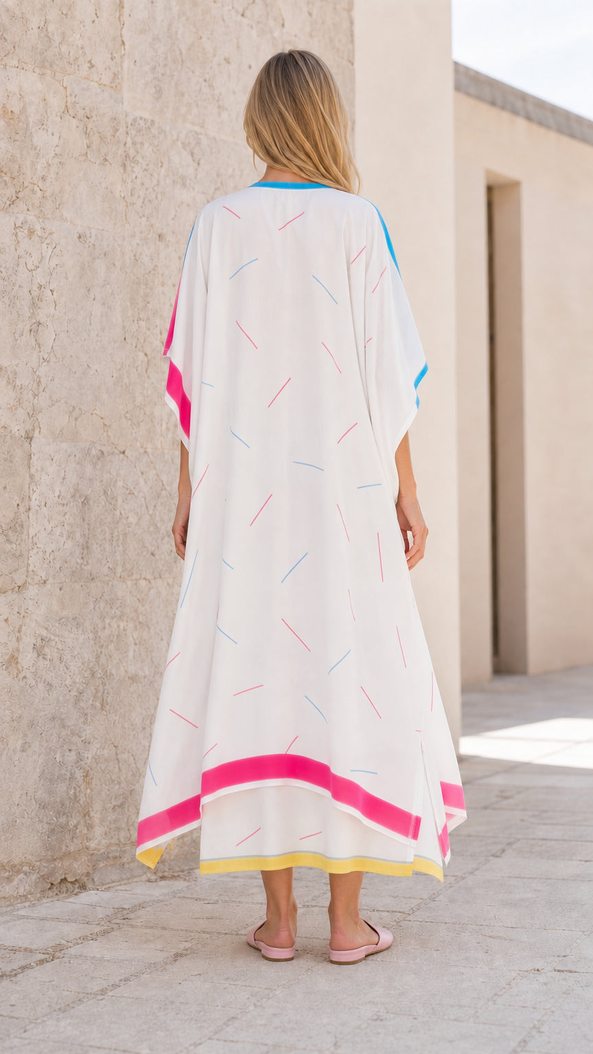 Back view of model wearing white kaftan maxi dress
