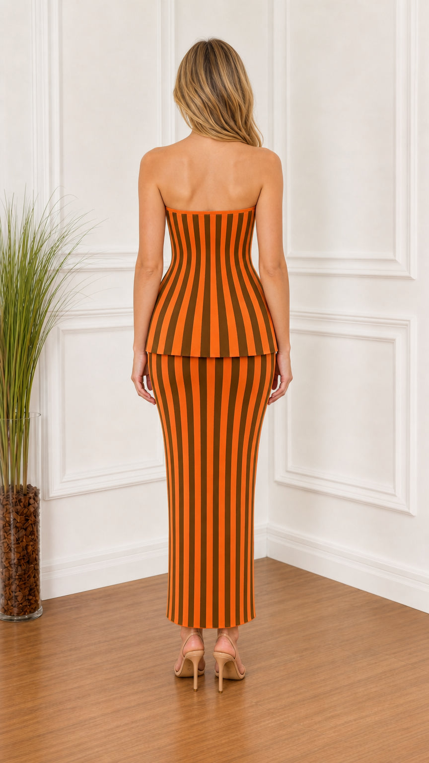 Back view of model wearing orange striped two-piece set