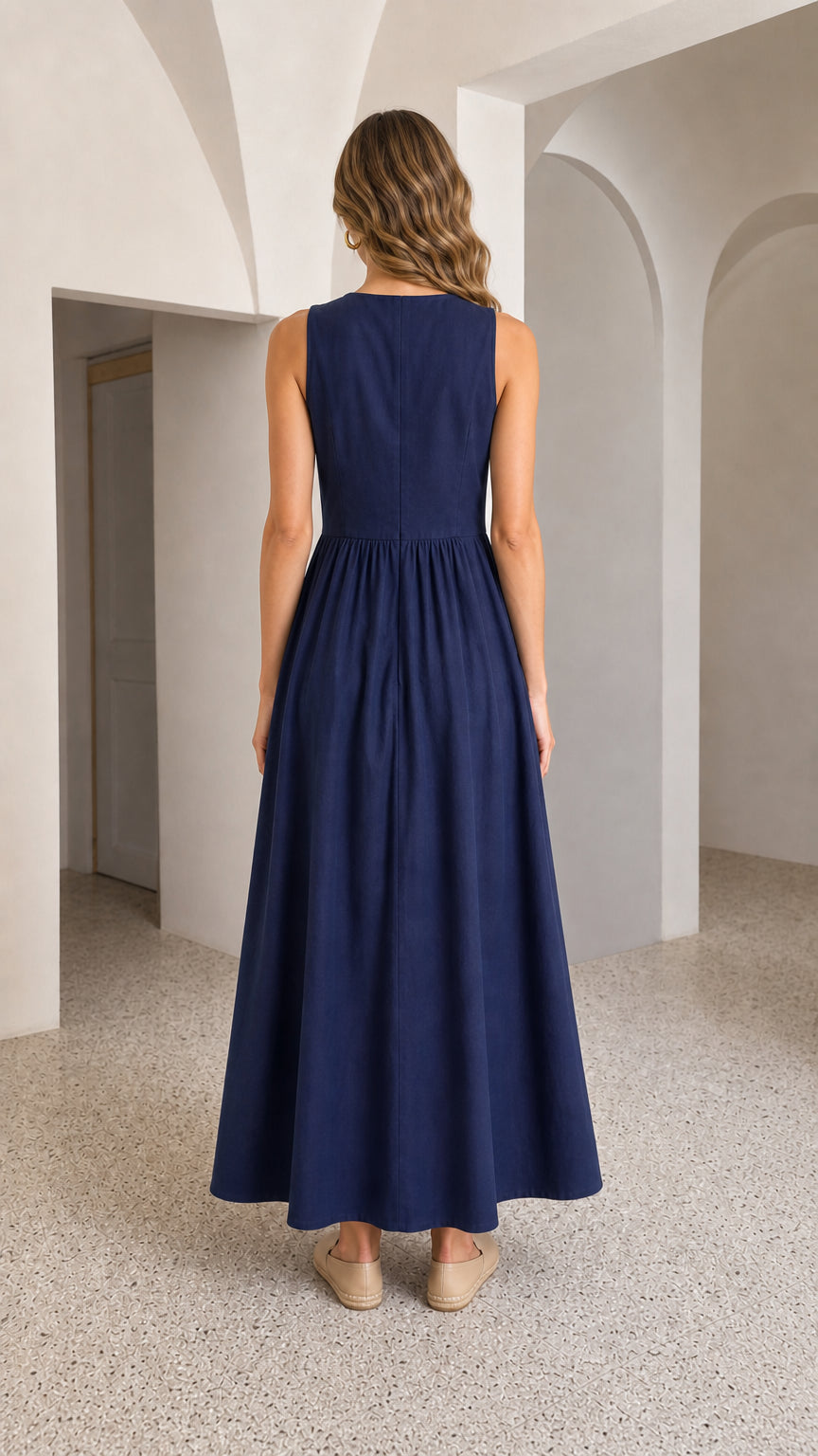 Back view of woman wearing navy maxi dress highlighting back neckline