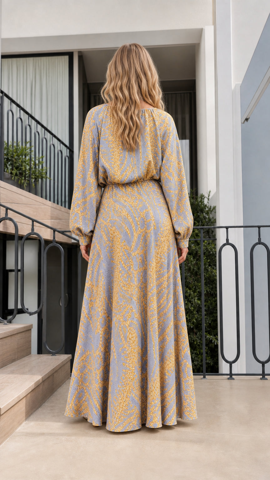 Back view of model in blue printed maxi dress