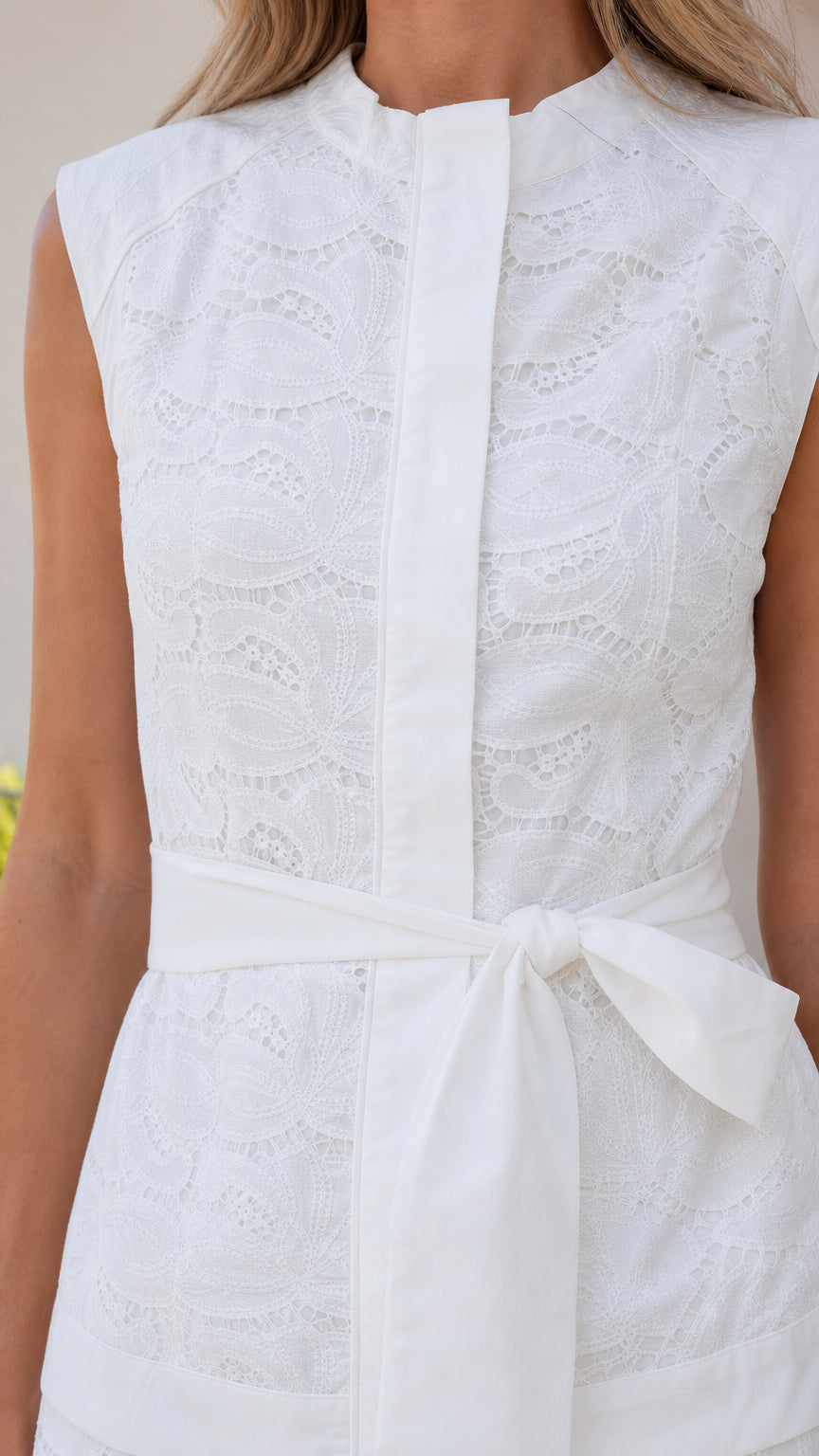 Close-up of the lace texture and mock neck on the white jumpsuit