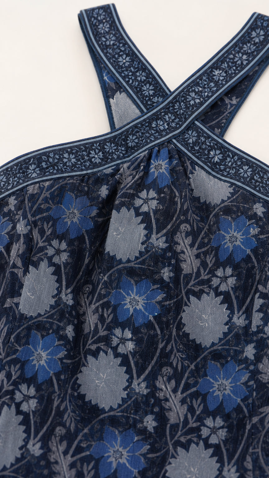 Close-up of blue floral print and crossover halter straps