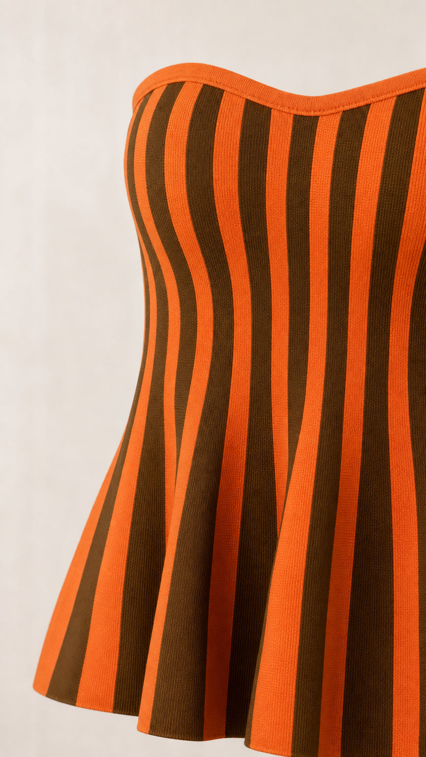 Close-up detail of the strapless peplum top texture and stripes