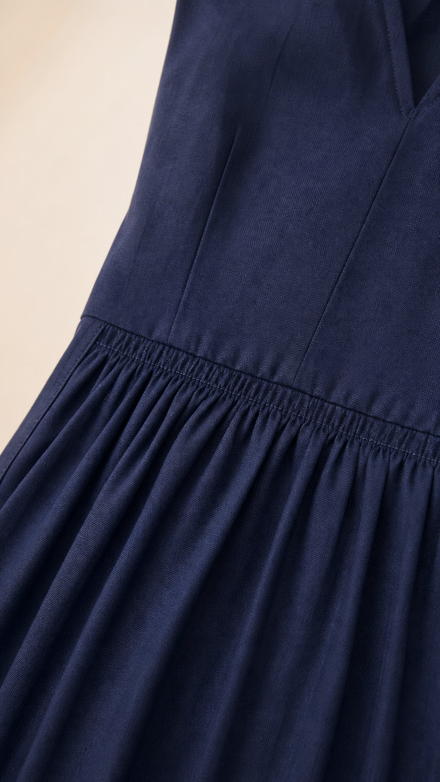 Close-up of navy dress bodice and gathered elastic waist detail