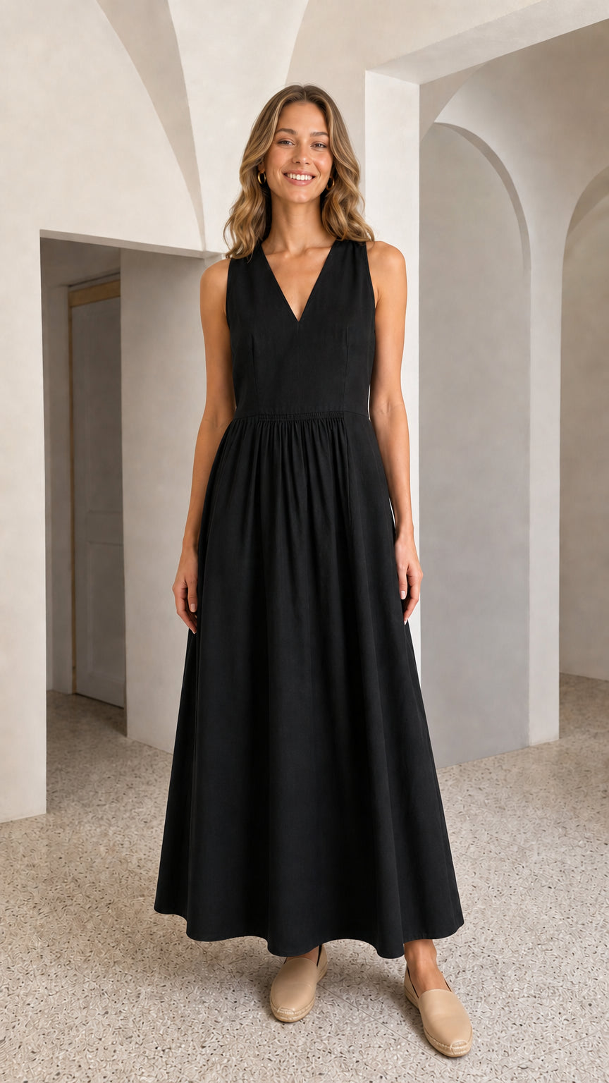 Woman wearing black V-neck sleeveless maxi dress