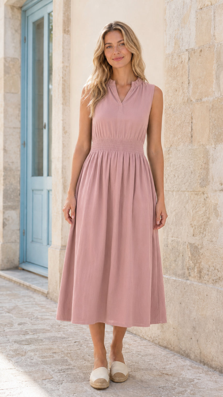 Full front view of woman wearing pink sleeveless smocked midi dress