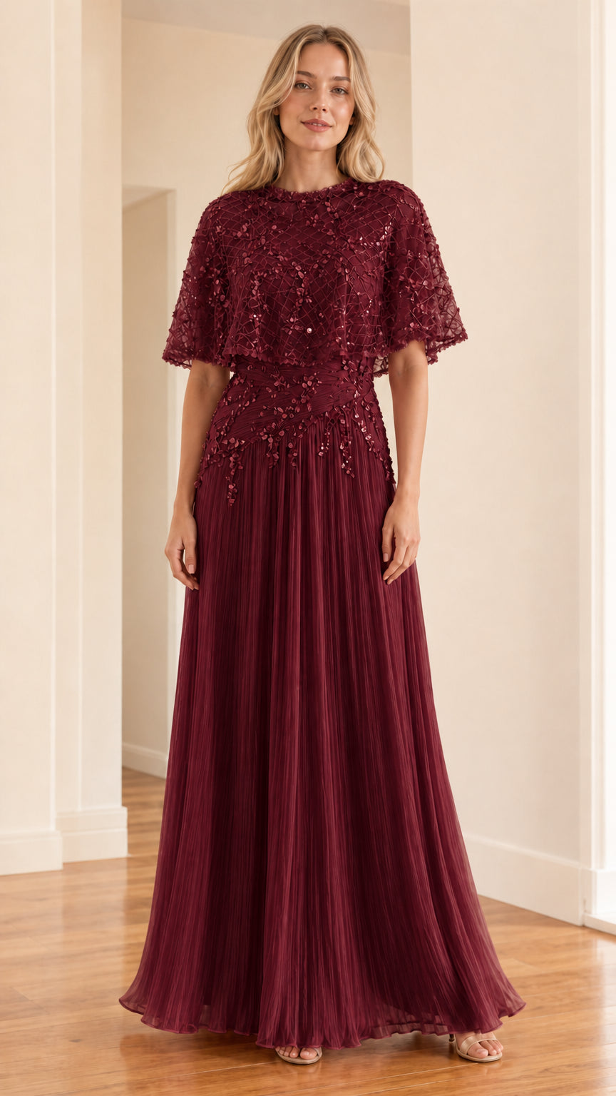 Front view of burgundy evening dress with cape overlay and pleated skirt