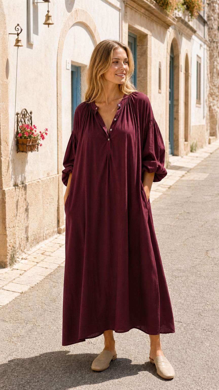 Front view of woman wearing burgundy long sleeve maxi dress