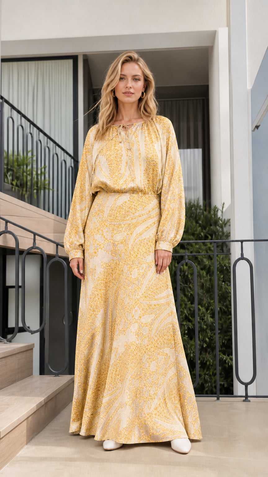 Model wearing yellow printed long-sleeve maxi dress